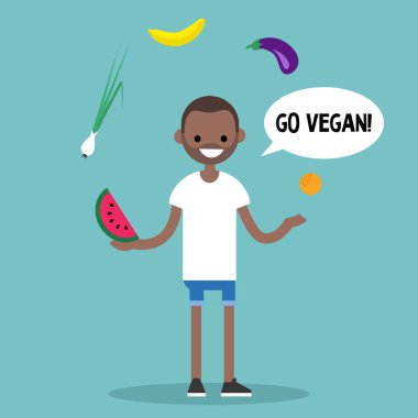 Modern bir yaşam tarzı. Vegan gidin. Genç siyah erkek hokkabazlık meyve ve sebze