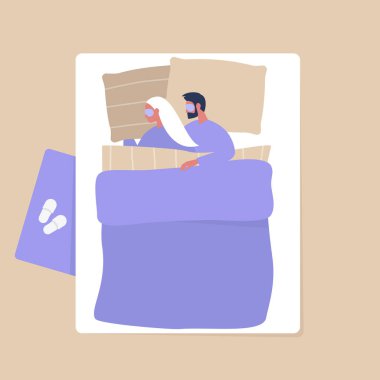 Genç bir çiftin battaniyenin altında sarılıp...