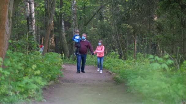 Uma Família Máscaras Médicas Caminha Parque Primavera Pai Carrega Seu — Vídeo de Stock