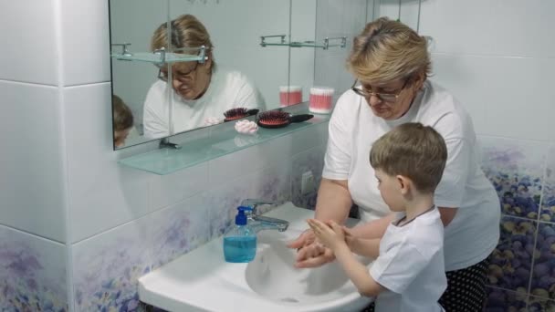 Grandmother Teaches Little Boy How Wash Her Hands Soap Sink — Stock Video