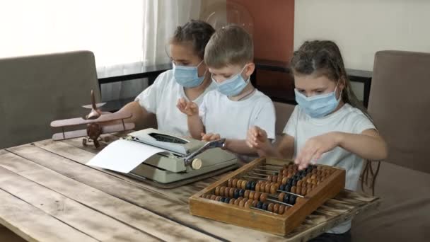 Two Girls Boy Medical Masks Play Wooden Toys Bills Typewriter — Stock Video