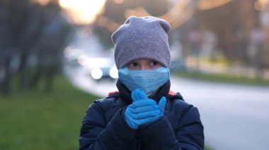 Çocuk koruyucu bir maske ve eldiven takıyor. Çin koronavirüsüne karşı koruma. Gelecek nesilleri düşün. Salgın ve salgın hastalık kavramı