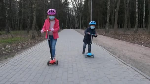 Little Boy Girl Ride Scooters Medical Masks Park Concept Protection — Stock Video