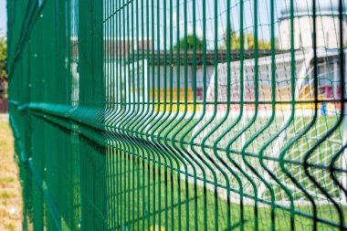Green protective grid close-up. The pattern of a protective grid for a sports ground. Sports background. clipart