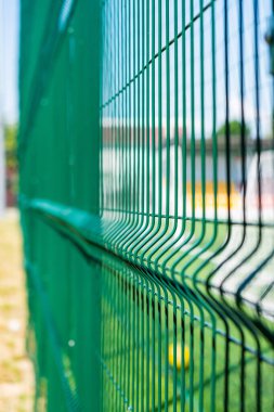 Green protective grid close-up. The pattern of a protective grid for a sports ground. Sports background. clipart