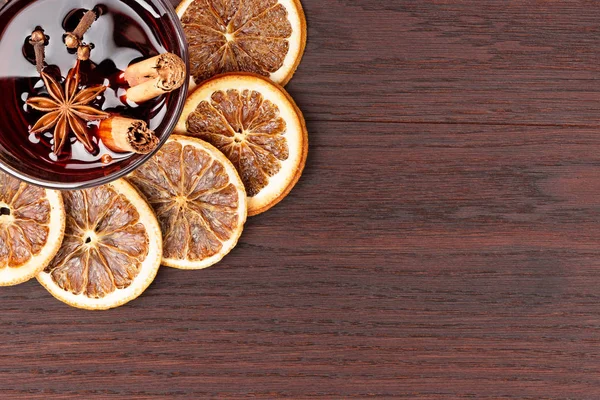 Mulled wine and orange slices on wooden background — Stock Photo, Image