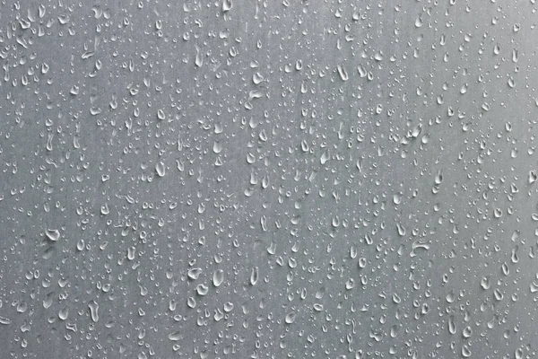 Close up of raindrops on a grey surface — Stock Photo, Image