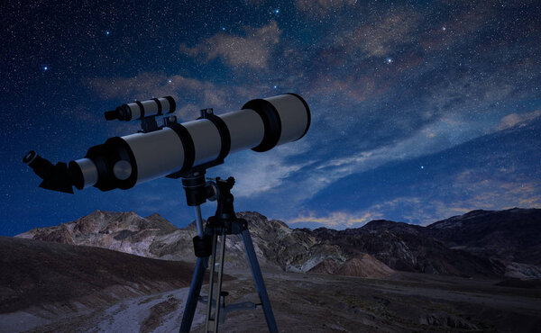telescope on a tripod pointing at the night sky