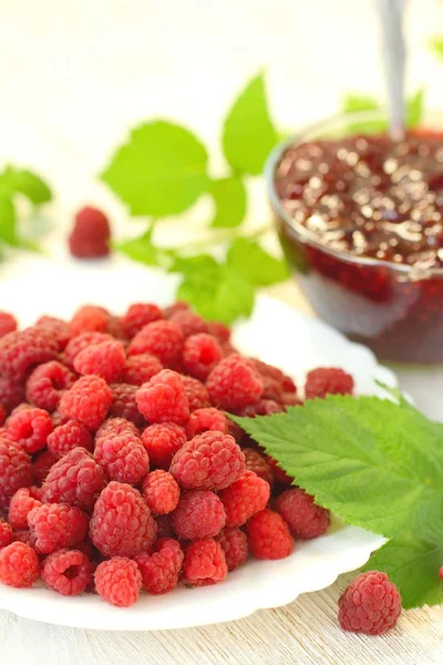 Confiture de framboises dans un bol et baies fraîches sur la table — Photo