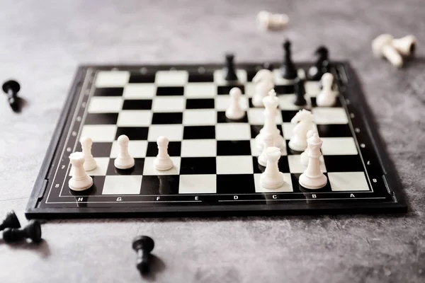 chess figures, a chess game on a modern plastic chessboard