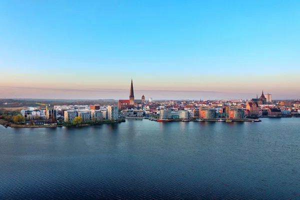 panoramic view of the city of rostock - aerial view over the river warnow, skyline during sunrise in the morning