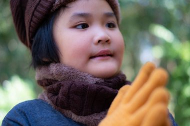 Portrait of a cute little girl in wool hat  clipart