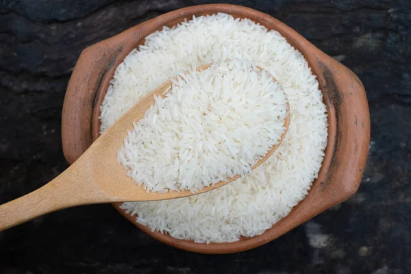 Saque el arroz utilizando un cucharón en una olla de barro — Foto de Stock