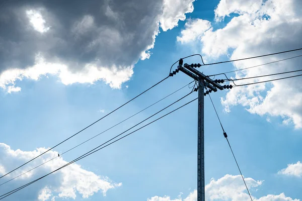 Electricity concrete post and high voltage wire at sky backgroun