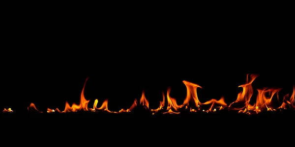 On fire flames at the black background — Stock Photo, Image