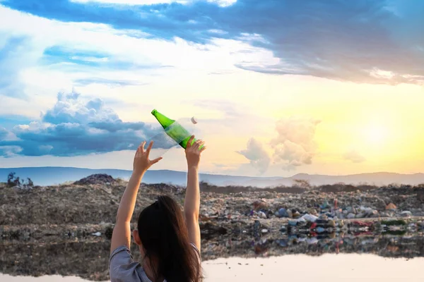 The back woman stands in hand have green glass bottle and clear