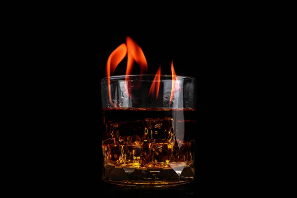 Glass with whiskey of Ice cube and fire flame on black backgroun — Stock Photo, Image