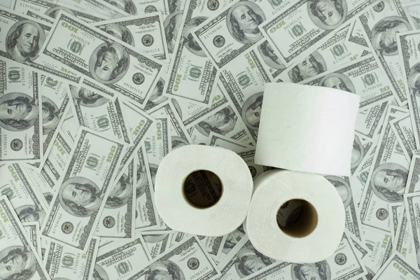 Toilet paper tissue and money of stack 100 US dollars banknote a lot of texture background, That was It costs expensive price and high priced products concept, top view, high angle