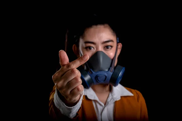 Businesswoman of young Asia woman putting on a respirator N95 mask to protect from airborne respiratory diseases as the flu covid-19 coronavirus PM2.5 dust and smog, Women hand sign mini heart
