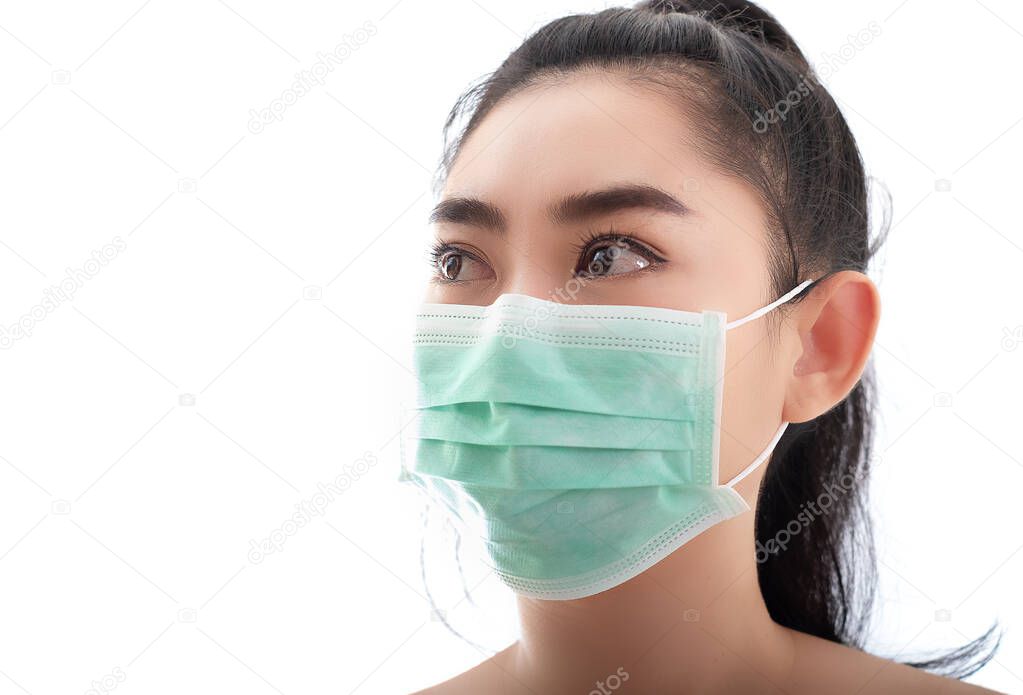 Beautiful young Asia woman putting on a medical mask to protect from airborne respiratory diseases as the flu covid-19 PM2.5 dust and smog, Women safety virus infection concept