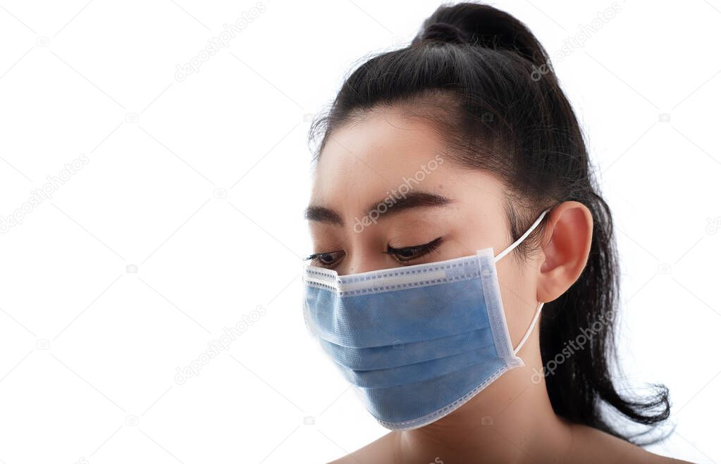 Beautiful young Asia woman putting on a medical mask to protect from airborne respiratory diseases as the flu covid-19 PM2.5 dust and smog, Women safety virus infection concept