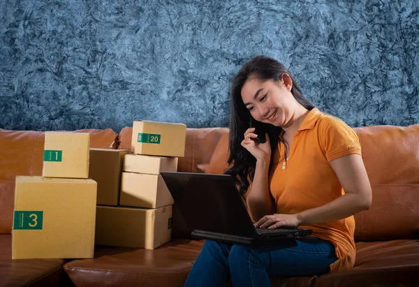 Portrait Bored Asia young woman is sitting on the sofa at her room, Women used  mobile phone on concrete wall background, A lady is bored because sales dropped from sales target concept