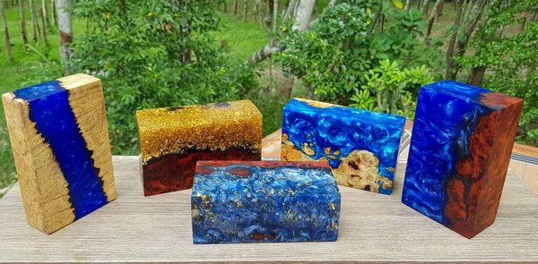 Casting epoxy resin burl wood cube on table art background, Nature wooden
