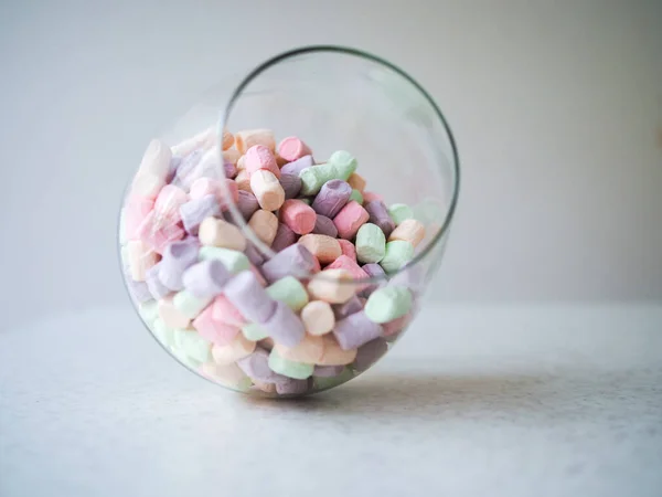 Gentle marshmallow in glass vase isolated on white