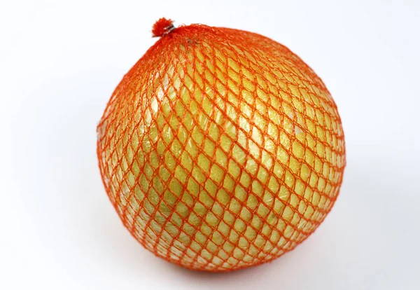 A ripe pomelo is packaged in a grid on a white Royalty Free Stock Photos