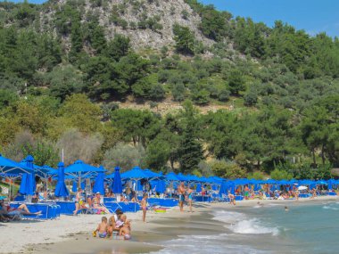 People relaxing on a beach. Thasos Island, Greece - september, 2014