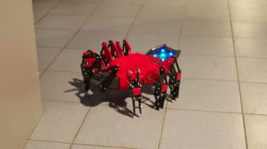Örümcek robot. Altı bacaklı robot oyuncak yerde yürüyor. Modern robot oyuncakları