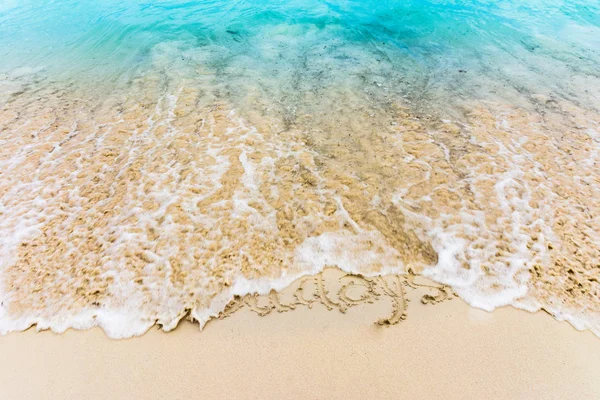 Holidays drawn on the sand and cleared by the caribbean sea — Stock Photo, Image