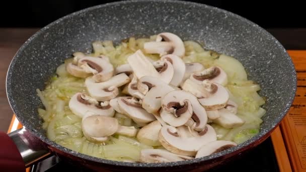 Onion frying in a frying pan in butter, close-up — Stock Video