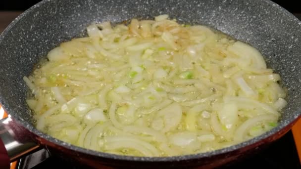 Onion frying in a frying pan in butter, close-up — Stock Video