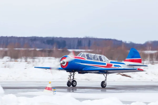 Small plane at the airport in winter