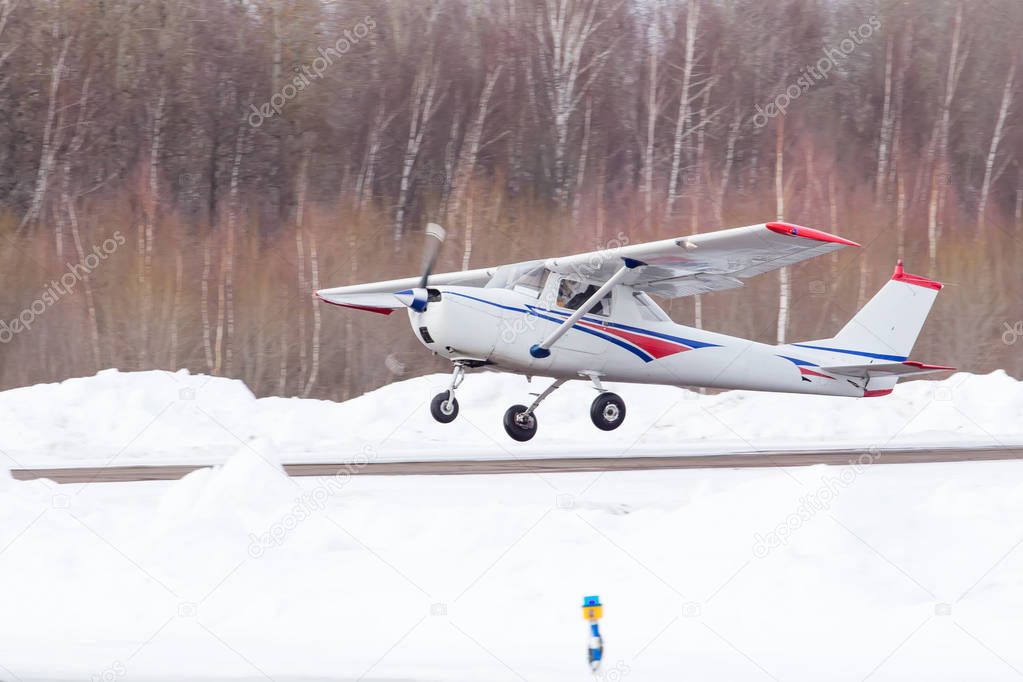 Small plane at the airport in winter