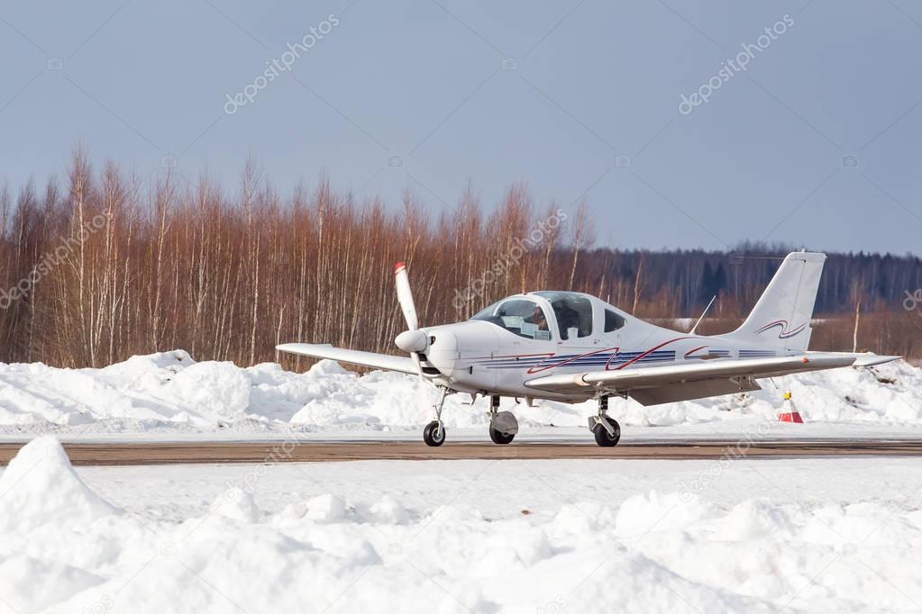 Small plane at the airport in winter