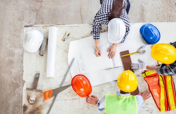 Müdür ve mühendis endüstriyel inşaat sahasında takım çalışması olarak çalışırlar. Mutluluk dolu bir çalışma hayatı olan bu iş için güvenlik ve tasarım ile birlikte ekipman dökümanı çizimi ile toplantı ve konsept planı için.