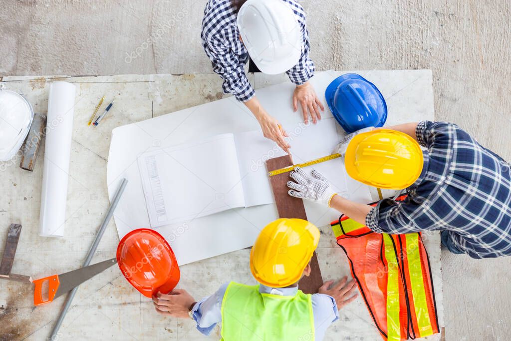 manager and engineer work as teamwork together at industrial construction site for meeting and concept plan with equipment document drawing of building with safety and design for thie job in office with happy work life