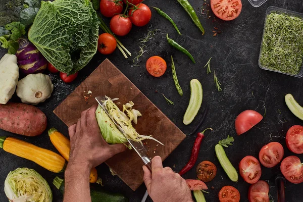 Erkek lüks kesme tahtası tablosundaki çeşitli sebze, üstten görünüm dolu lahana kesim eller