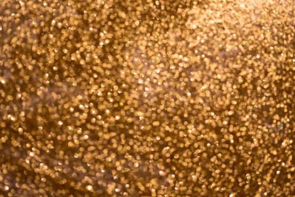 Gouden glitter bokeh textuur met plaats voor tekst: kerst, feest, feest, uitnodiging abstracte achtergrond — Stockfoto