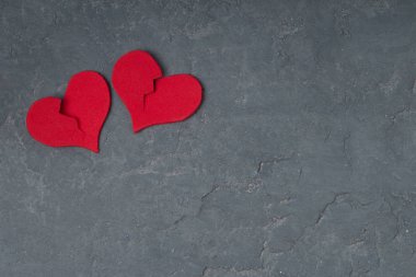 two broken hearts on concrete background. copy space . unhappy l clipart