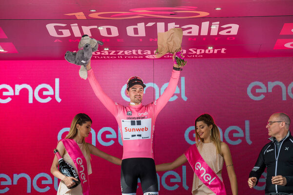 Canazei, Italy May 24, 2017: Tom Doumulin, in pink jersey of the best rider, on the podium after a hard montain stage of Tour of Italy 2017 that finish in the center of Dolomites.