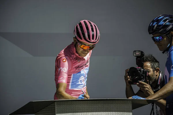 Valdaora, İtalya 30 Mayıs 2019: Richard Carapaz, pembe formalı, Giro D 'Italia 2019 dağının sert bir sahnesinde podyumda imza veriyor..