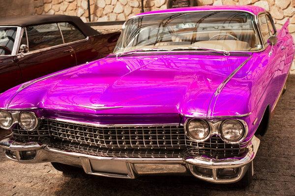  Vintage classic retro car. Beautiful pink auto, front view.