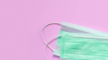 Koronavirüsü önle. Tıbbi maske, pembe arka planda izole edilmiş tıbbi koruyucu maske. Coronavirus hijyen konsepti