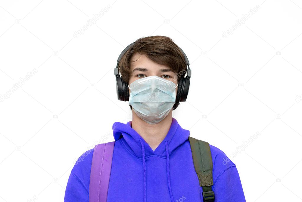 teenager at home training in a medical mask and with a backpack isolated during coronovirus. Copy space. lilac color