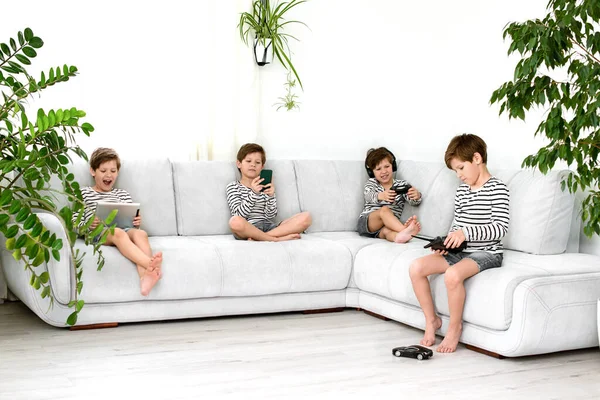 Collage - kids and gadgets. Using a phone, tablet, console game console and car on a remote control. game addiction