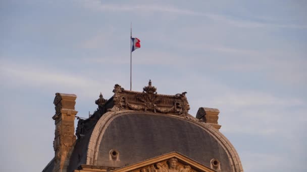 Flag of France waving in the wind. Flagpole is installed on roof Louvre Museum — Stock Video