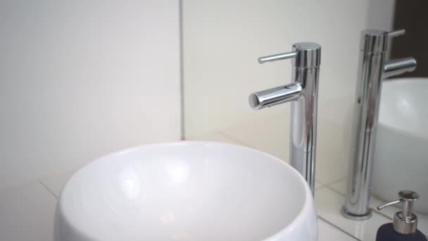 Bathroom. Sink and faucet close-up. Male hand opens and closes the water. 4K — 图库视频影像